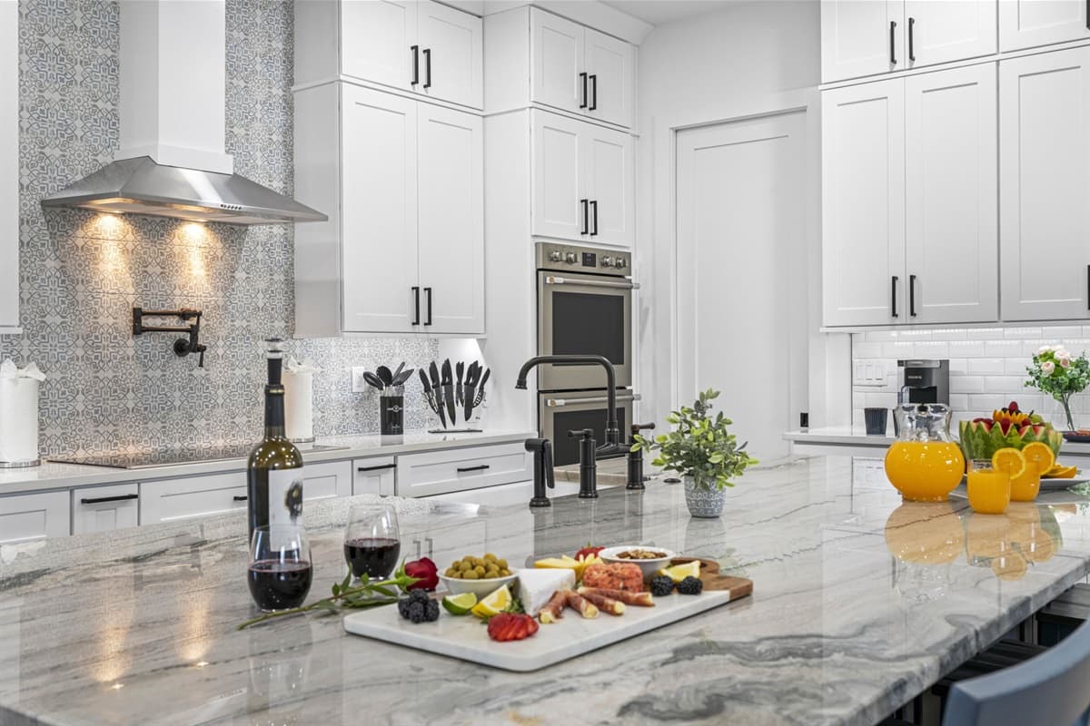 Custom cabinetry and polished countertops add to the kitchen’s stylish appeal, with well-organized storage solutions that keep everything you need within easy reach.