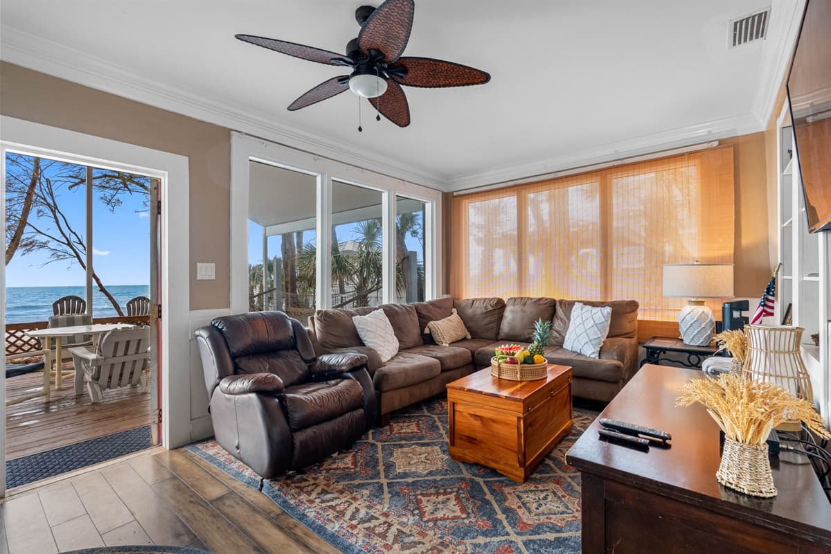 Soft, plush seating arrangements, including a cozy sofa and armchairs, provide ample space for family and friends to gather, whether for lively conversations, movie nights, or simply unwinding with a good book.