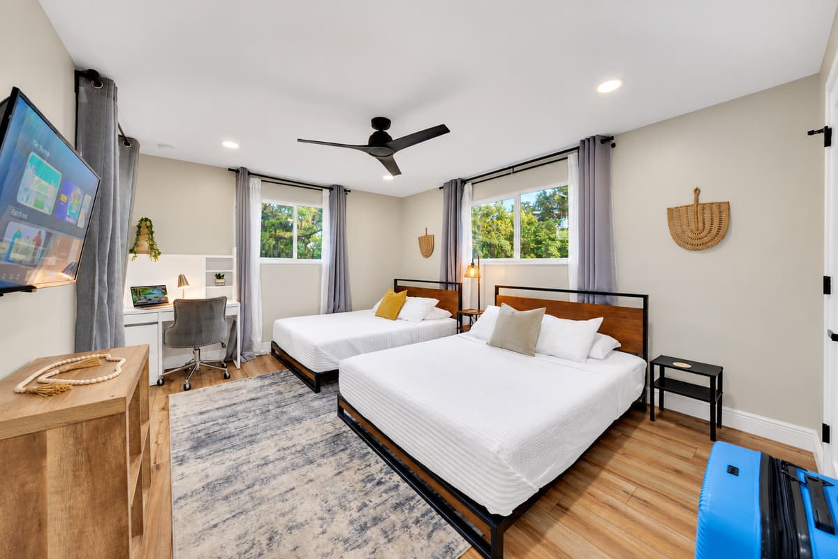 Two queen beds' worth of comfort in one bright room. Smart TV, wide dresser and windows onto the garden. The flexible bedroom that works for whoever ends up assigned to it.