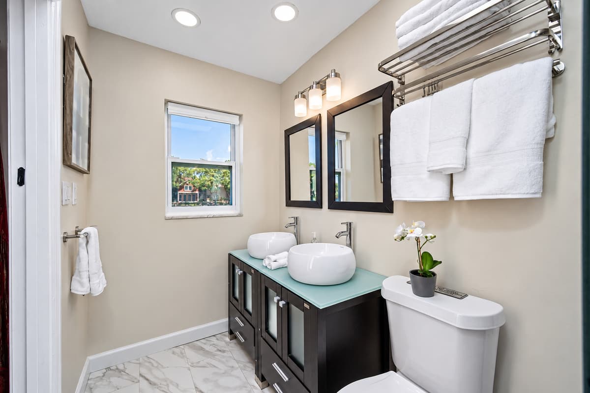 Beautiful bathroom equipped with his and hers sink, toilet, and shower. Enjoy a relaxing bath after a long day of travel from your home to your home away from home. If you think this property is for you, send us an inquiry right away!