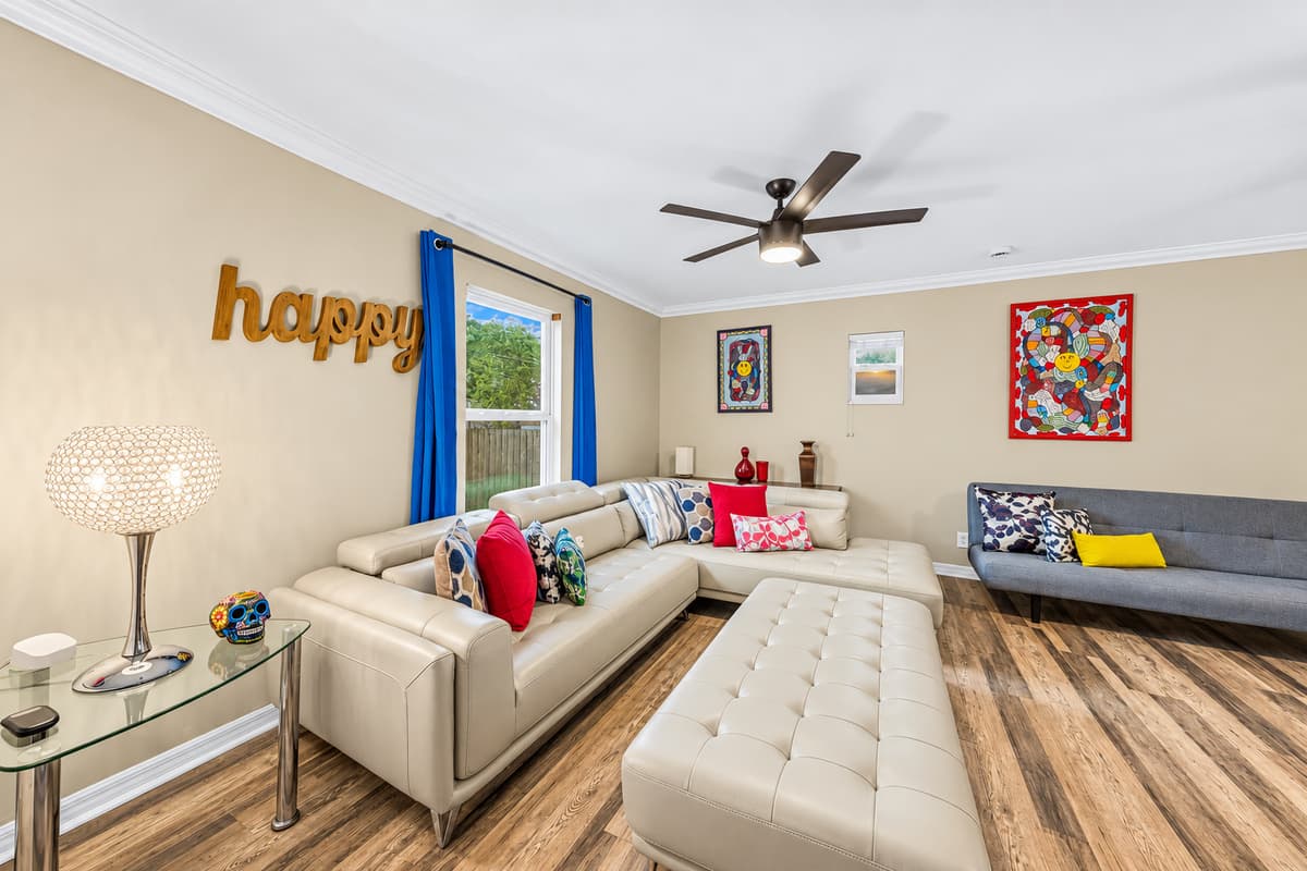 Bright and inviting living room with plush sectional seating, stylish décor, and plenty of space to relax.