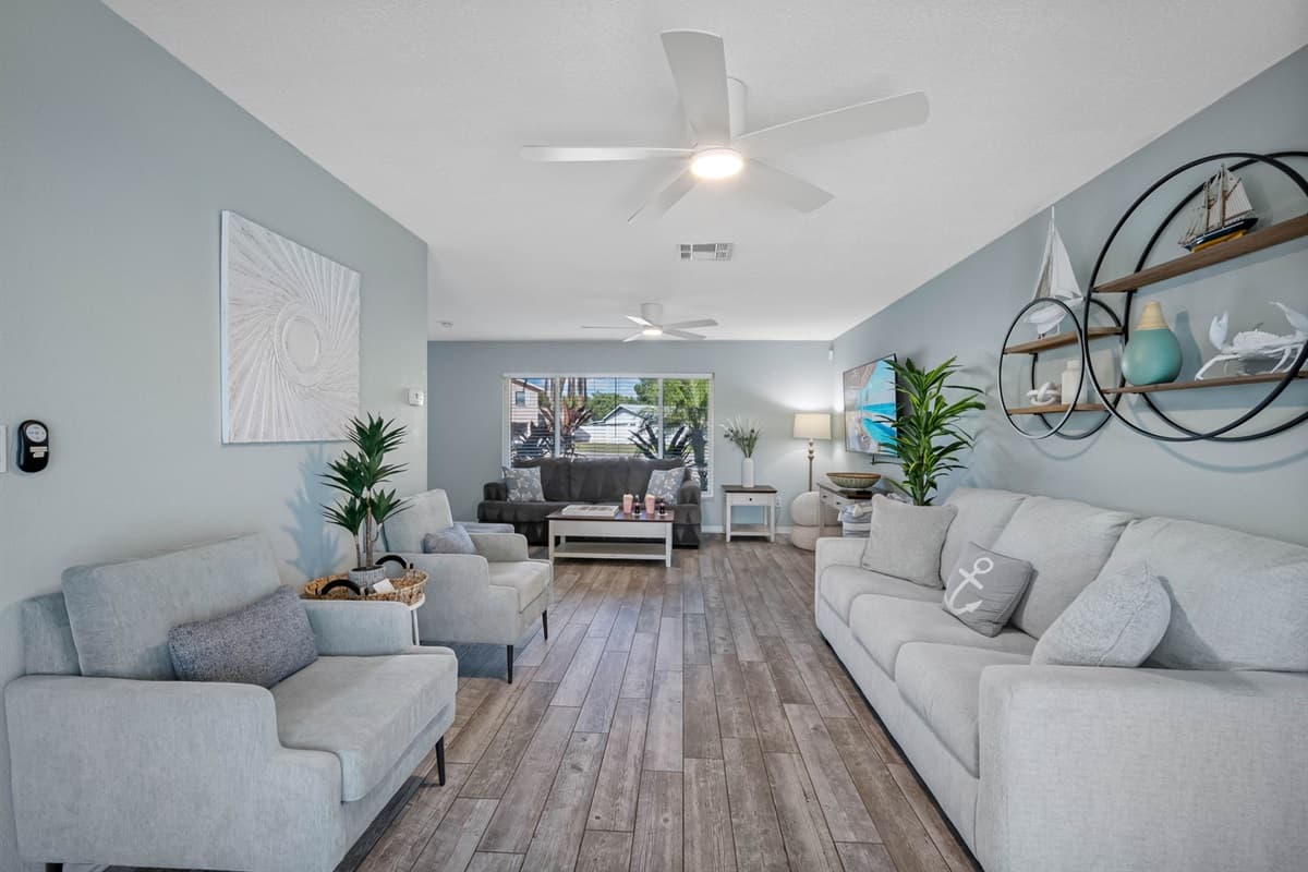 From cozy seating to poolside views, this living room is designed for comfort and connection.