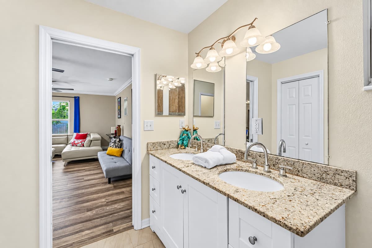 Bright bathroom with large vanity and easy access to adjacent living spaces.