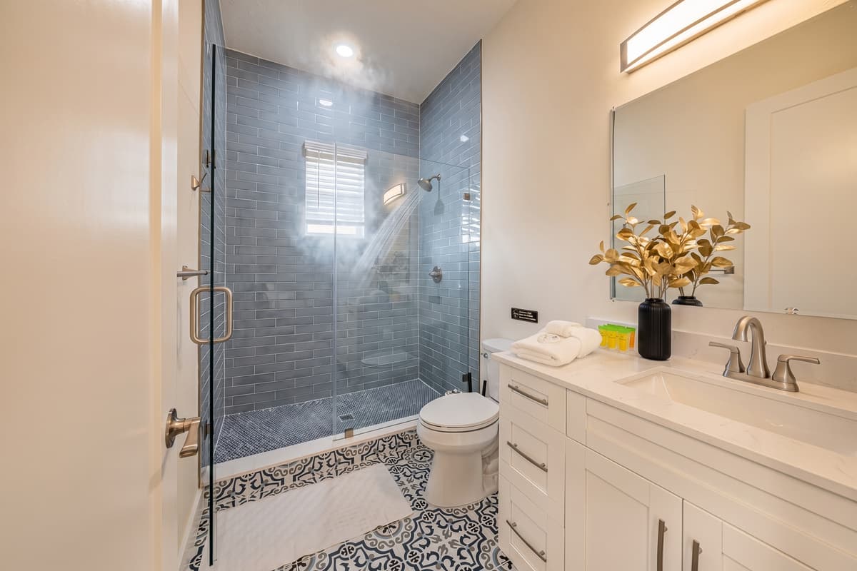 Stylish bathroom with glass walk-in shower and contemporary design.