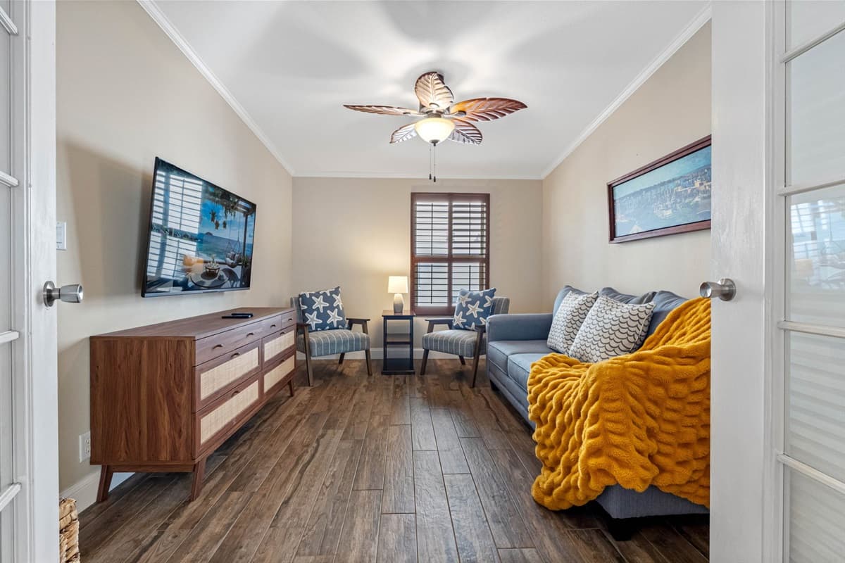 Featuring a comfortable sofa and two charming starfish-accented chairs, this serene space is ideal for relaxation, reading, or quiet conversation.