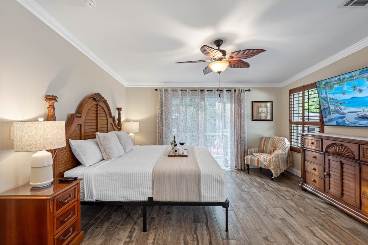 Relax in a beautifully styled master bedroom featuring a luxurious king bed, soft linens, and soothing neutral tones.