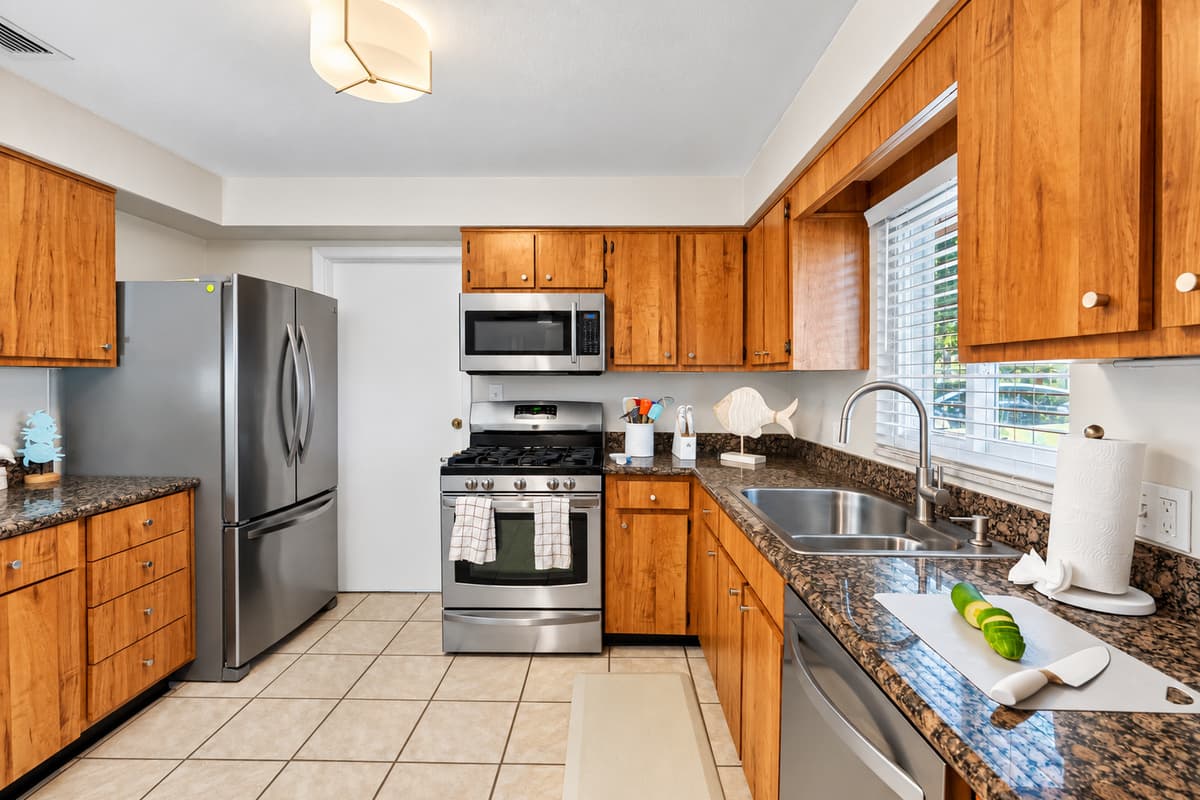 Granite countertops, gas stove, and dishwasher make cooking and cleanup a breeze in this practical space.