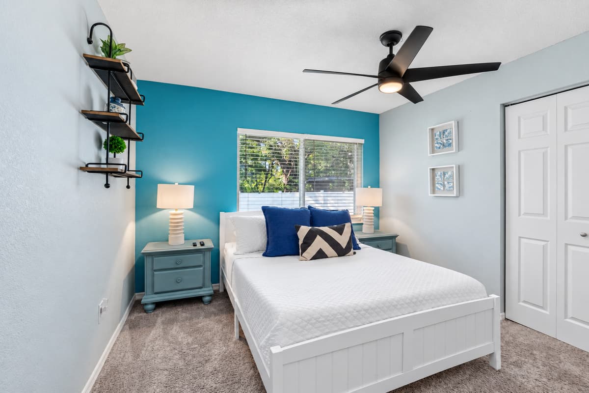 A soft, inviting queen room where modern design meets coastal charm — perfect for unwinding in comfort.