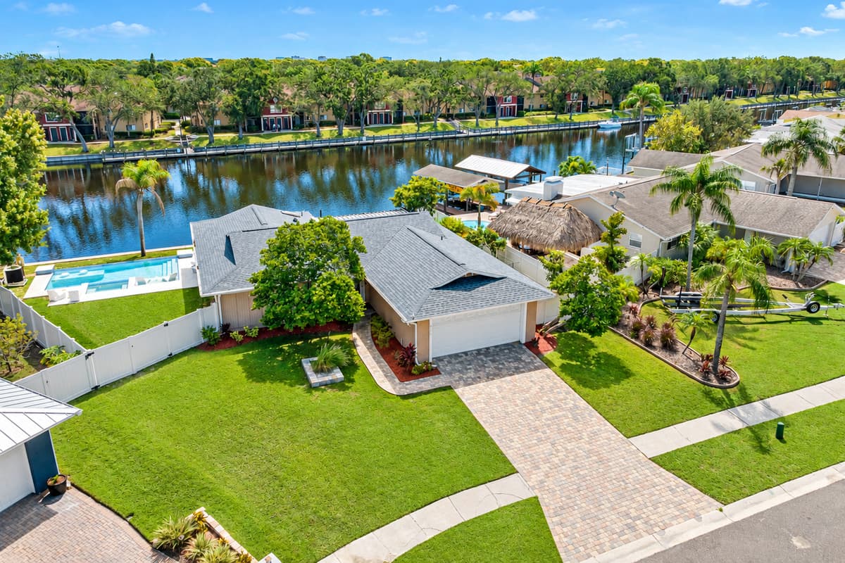 Aerial side view of our wonderful property what showcases our stunning heated pool, and beautiful driveway and our gorgeous fenced backyard. If you are interested in our property, send us an inquiry now!