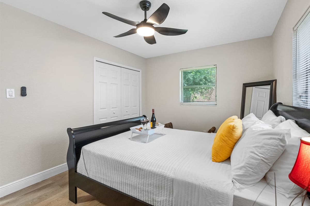 A modern ceiling fan with wide, sculpted blades and integrated lighting ensures the room stays cool, fresh, and well-lit throughout your stay.