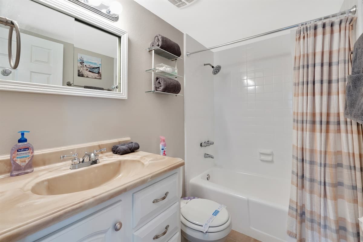 This bathroom features a combination tub and shower.