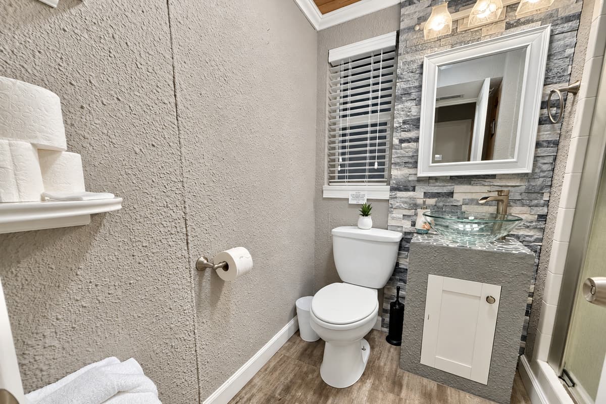 Equipped with modern lighting, beautiful tile work, and all the essentials—this space is practical and peaceful.