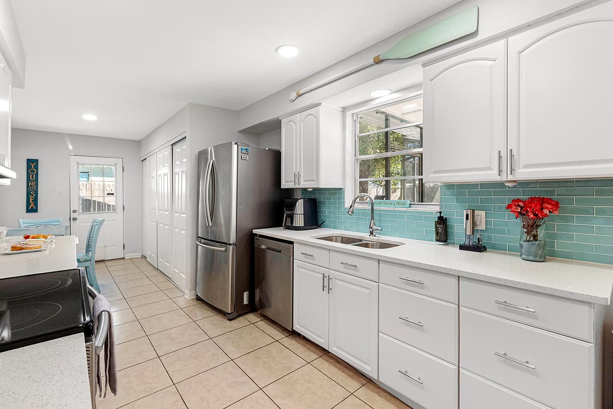 The heart of the home, the kitchen, is a bright and inviting space, fully stocked with all the essential appliances you'll need to create delicious meals throughout your stay.