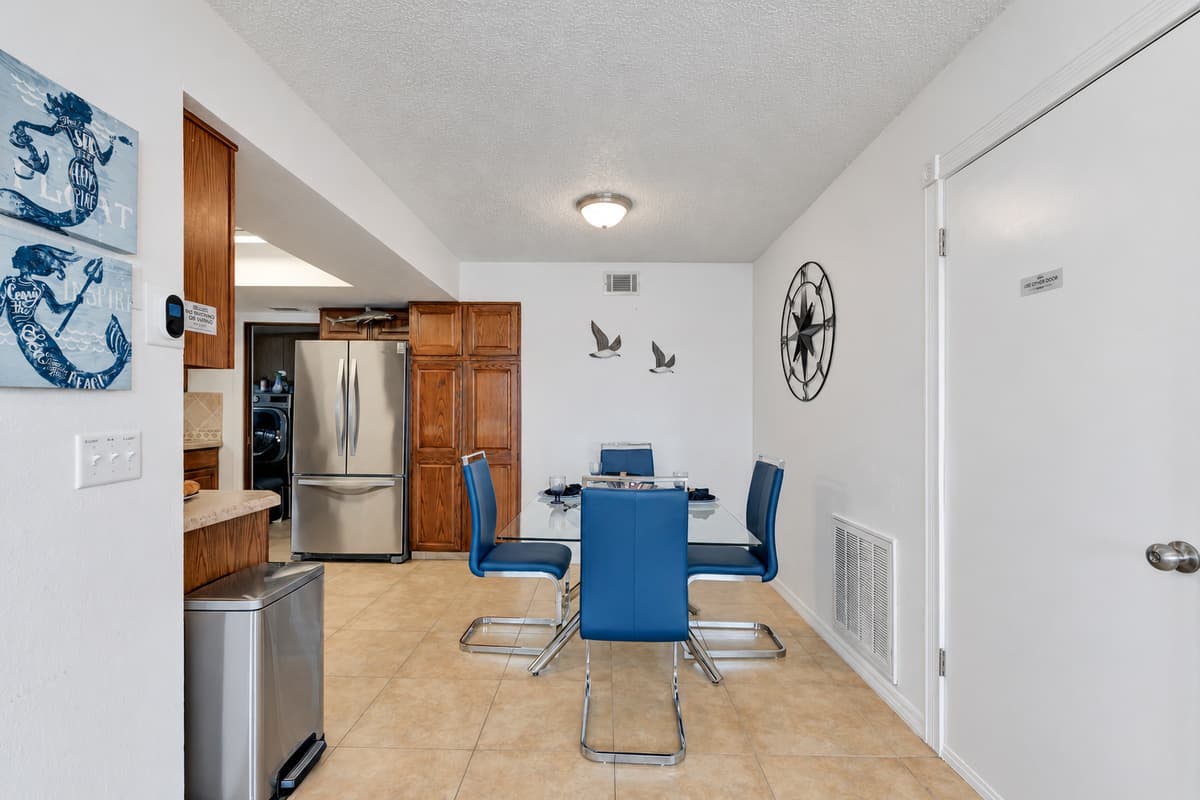 The area is well-lit with a combination of natural light from nearby windows and stylish overhead lighting, which creates a warm and welcoming ambiance, perfect for any time of day.