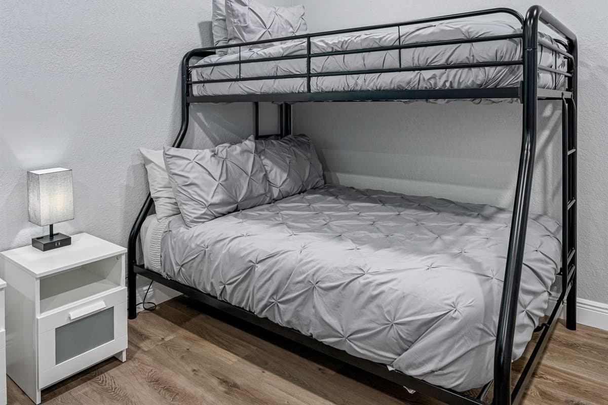 Two single over double bunkbeds for a small family or a group of friends who wants to hang out and sleep in one room. It is very spacious and has its own TV. If you are interested to book this house, Send us a message now!