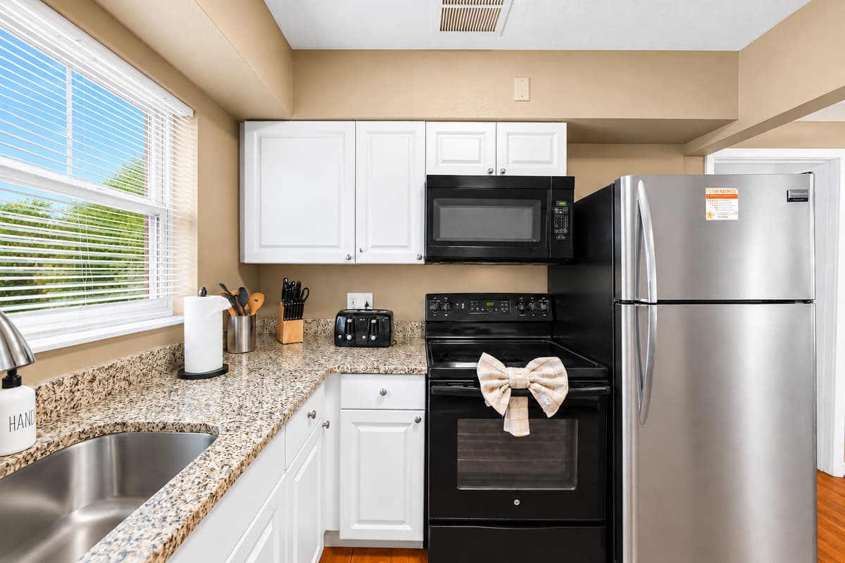 Cozy kitchen area with modern appliances, ample cabinetry, and bright natural lighting.