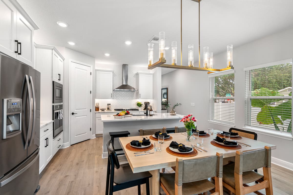 For added ambiance, the dining area features tasteful accents, such as a centerpiece on the table and nearby décor that ties the space together.