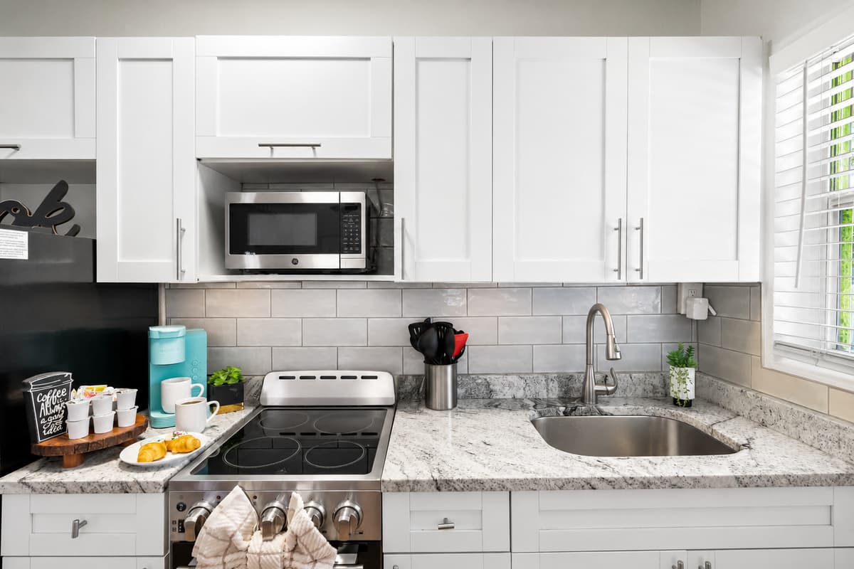 This clean, contemporary kitchen offers modern appliances, generous prep space, and all the comforts of home.