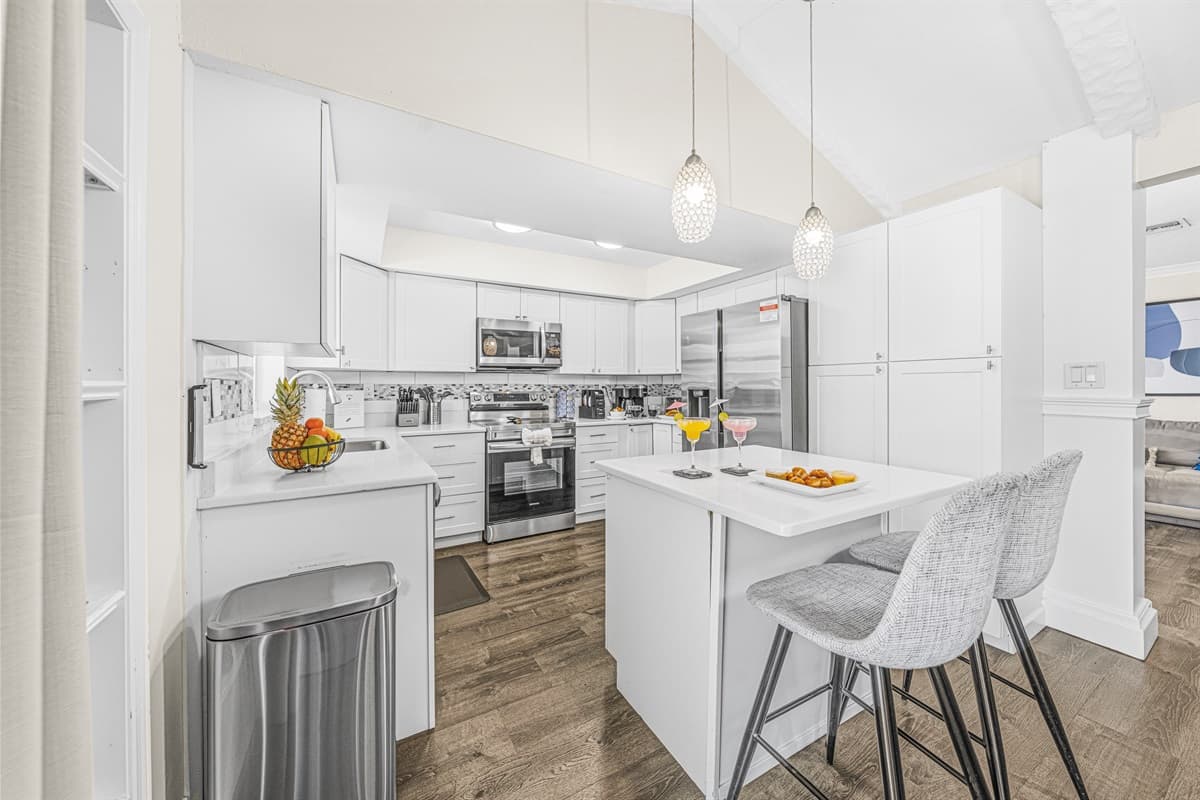 Open-concept kitchen with island seating and plenty of prep space for your group.
