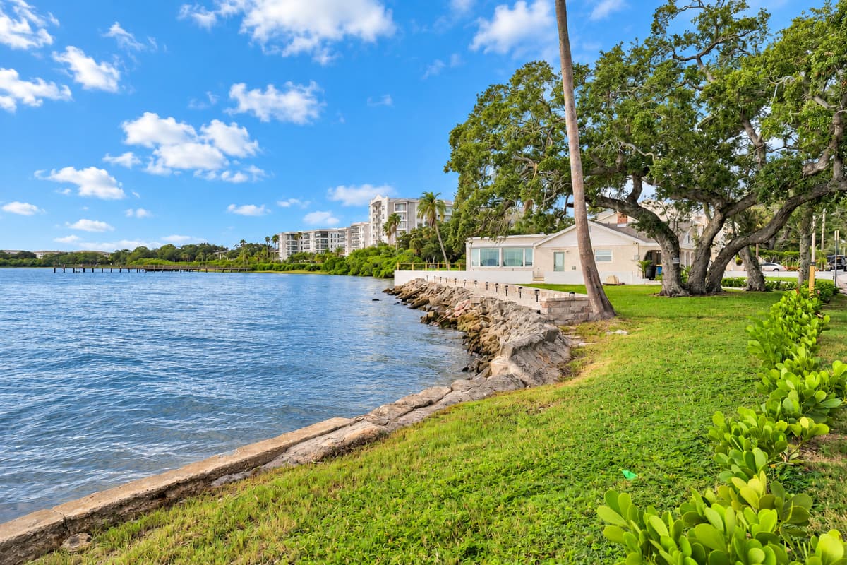Grassy lawn, rock seawall, open bay. A wide lawn rolls down to the seawall with calm bay water beyond. Perfect for a morning walk or a quiet moment with coffee.