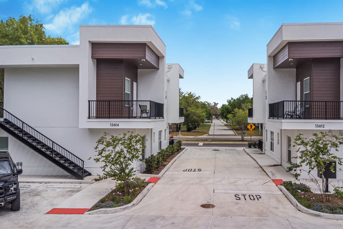 The KaSa complex: a modern, boutique retreat with private parking, landscaped walkways, and a welcoming neighborhood just beyond.