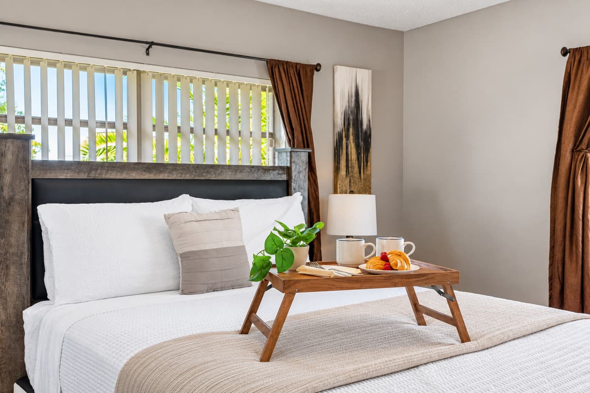 The cozy bed dressed in crisp white linens makes this space perfect for relaxation and restful sleep.