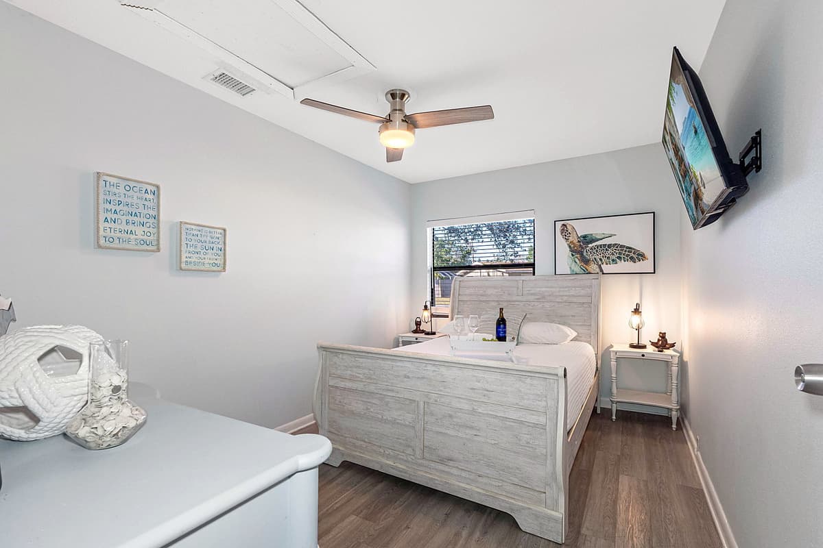 This bedroom features a plush queen-size bed, dressed in soft, high-quality linens, ensuring a restful night's sleep for up to two guests.
