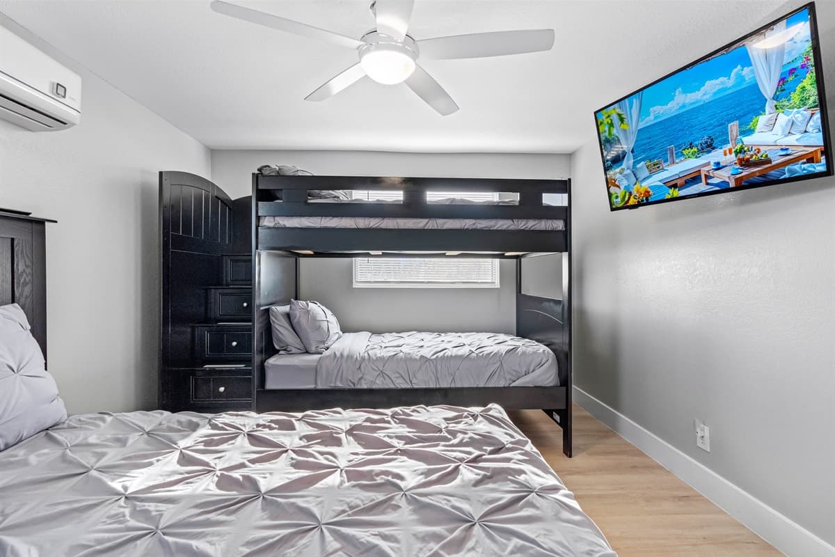 Indulge in the sophistication of our bedroom, featuring a queen-size bed and a smart TV. Relax and make lasting memories with your loved ones during your stay.