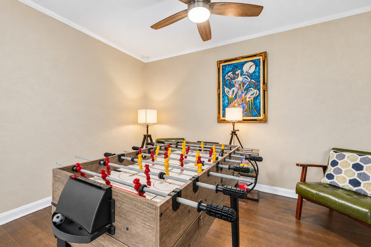 Dedicated game area with foosball table and comfortable seating for game nights.