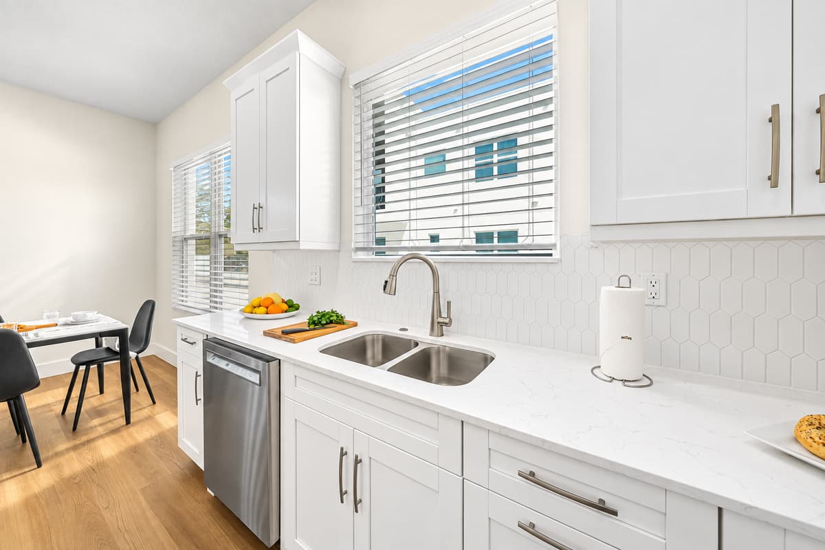 Bright kitchen with large window, double sink, and plenty of counter space for easy meal prep.