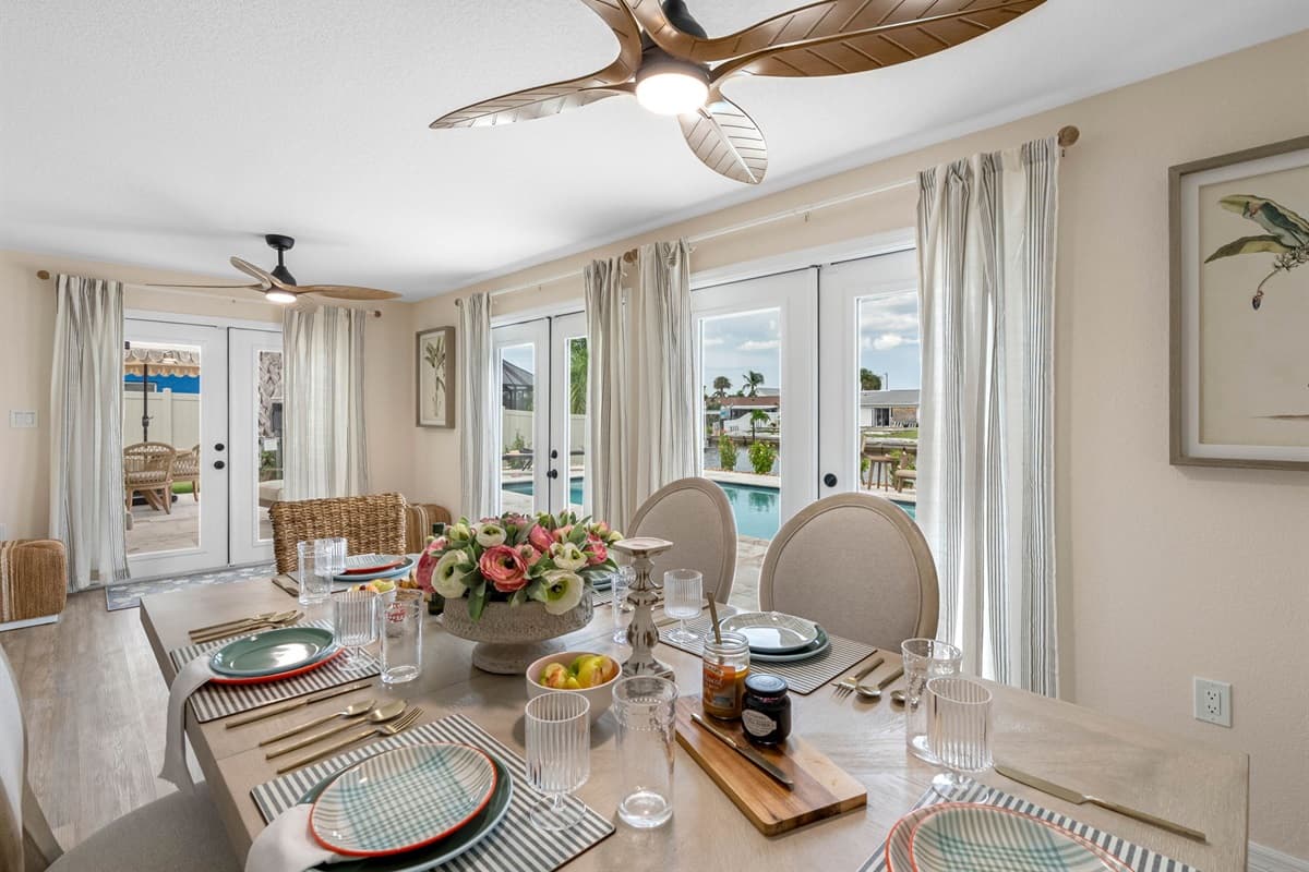 Gather around this beautifully styled dining table, featuring seating for six, a chic woven pendant light, and fresh floral centerpiece — perfect for shared meals and conversation.