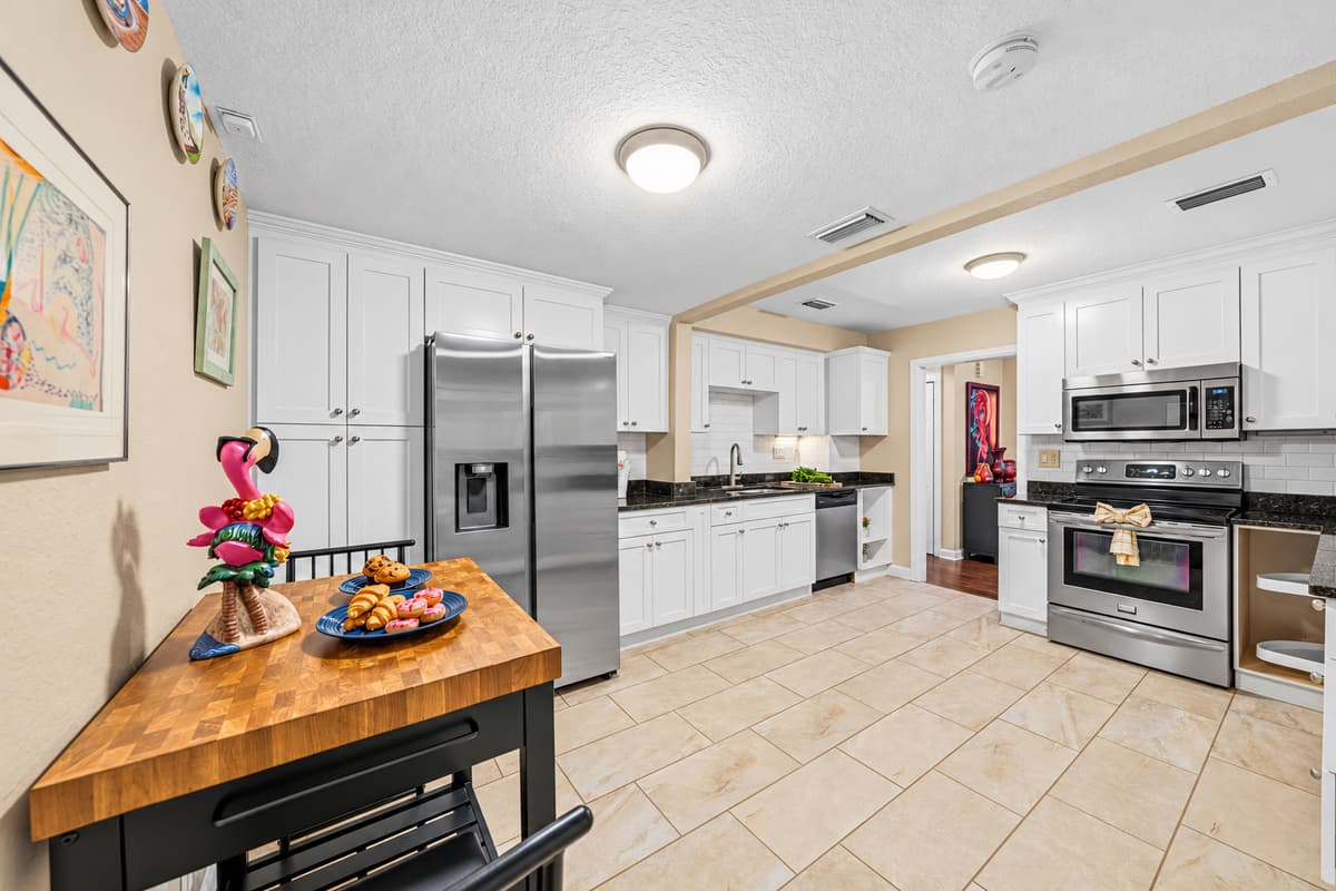 Open kitchen with island workspace and full-size appliances for added convenience.