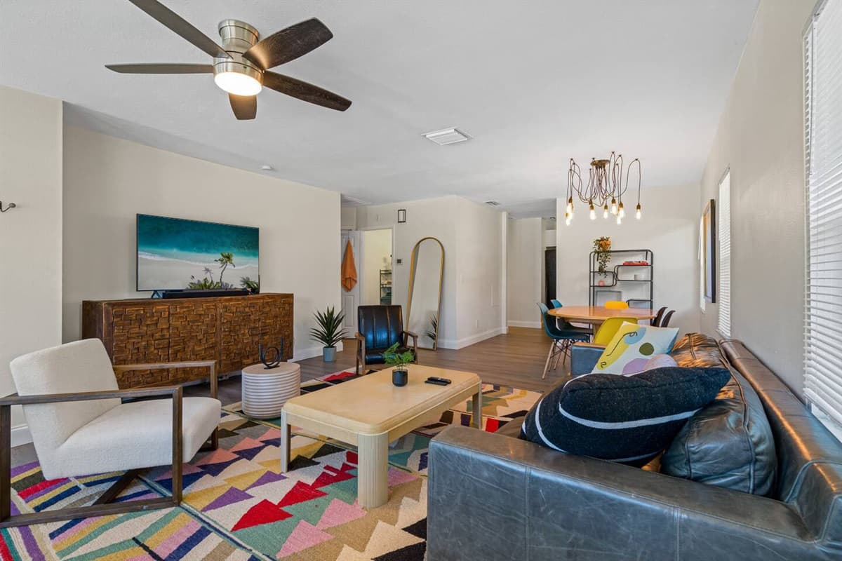 Modern living room equipped with a large flat-screen smart TV where you can chill and catch up on your favorite TV series. If you have any questions at all, please send us an inquiry today!