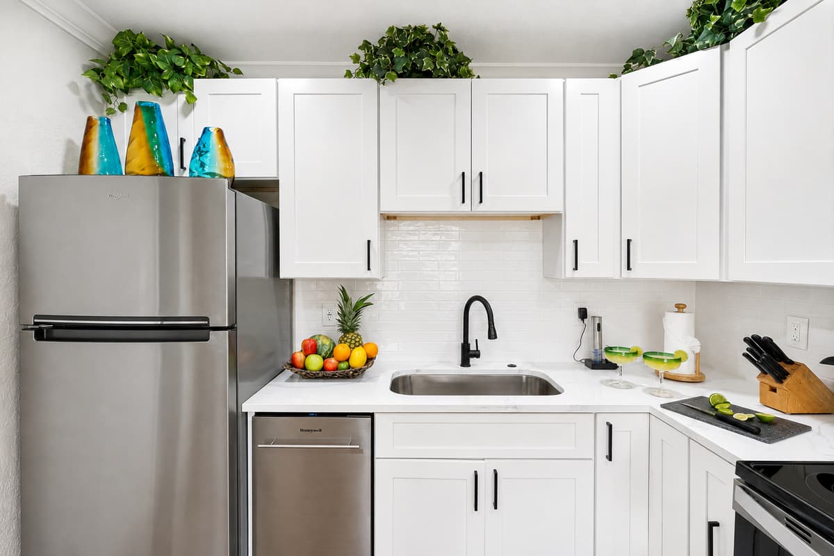 With its sleek cabinetry, polished countertops, and stainless steel appliances, the space offers both style and functionality.