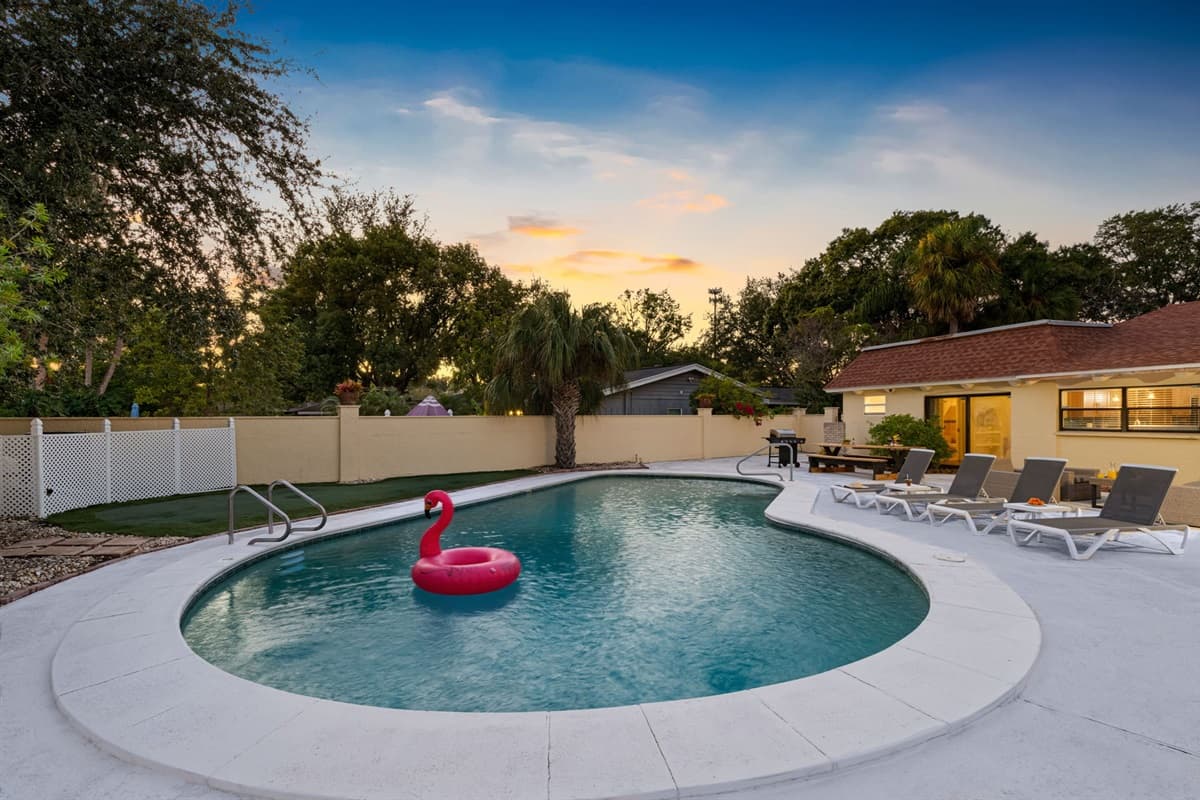 As the sun sets, the pool lights up for a cozy evening vibe — enjoy a quiet swim or sip wine under the glowing sky.
