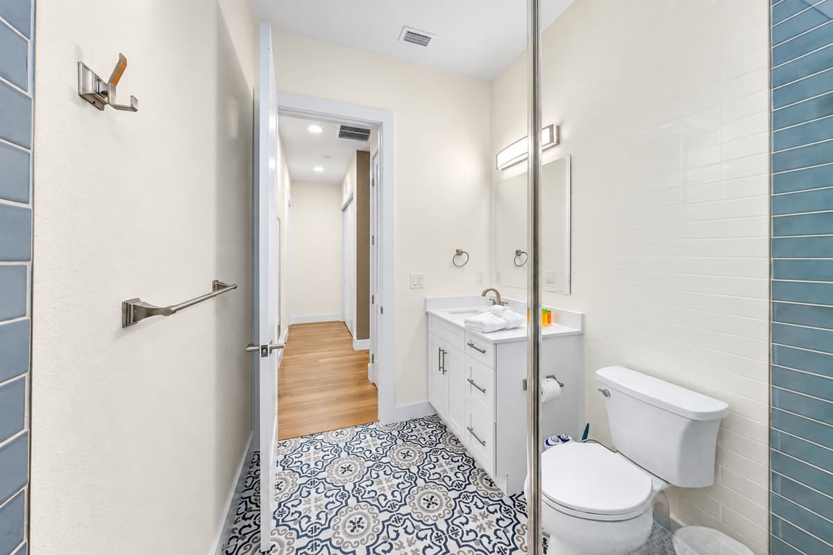 Bright full bathroom with modern vanity and clean finishes.

