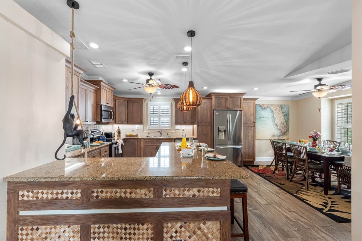 Designed for both beauty and practicality, the kitchen features warm cabinetry, granite surfaces, and everything needed to feel at home.