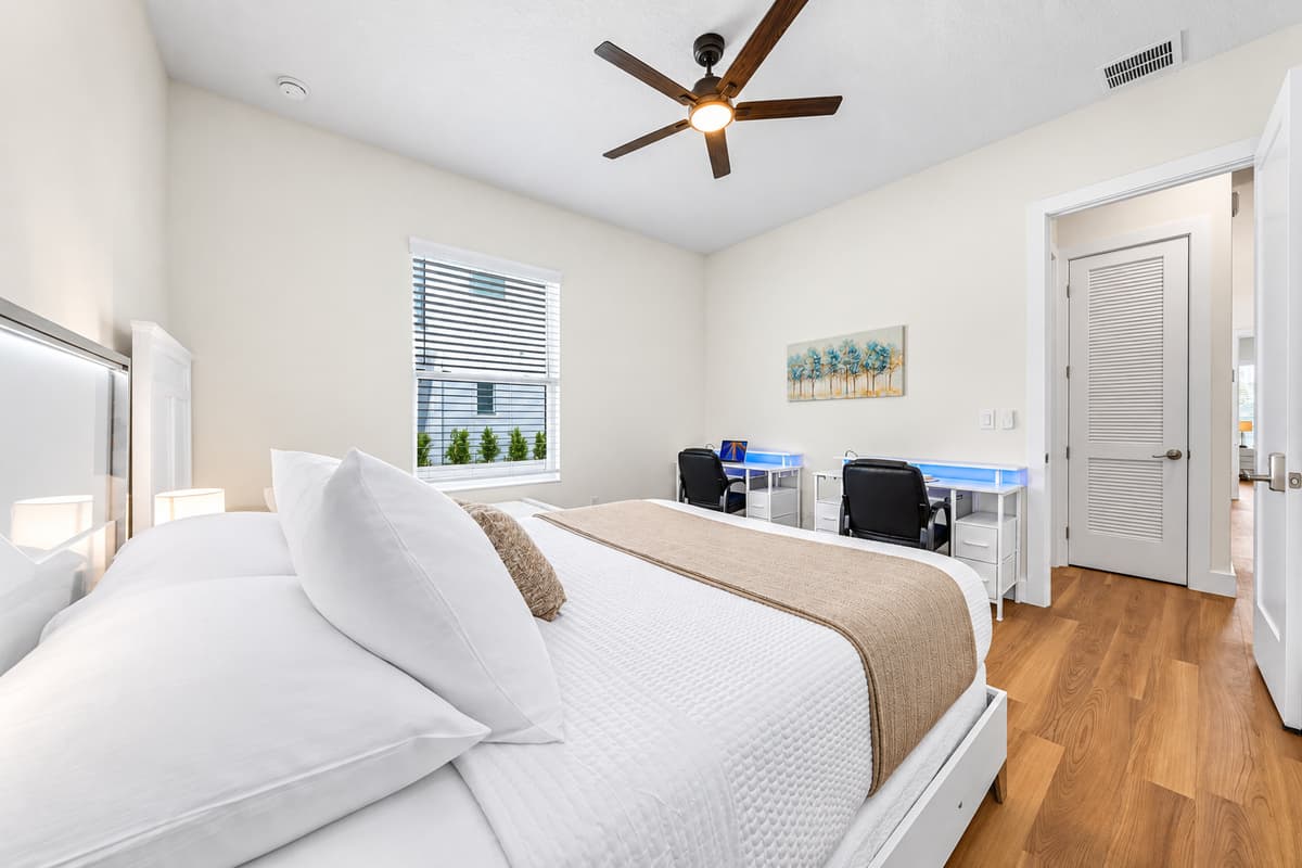 Spacious bedroom with multiple beds and workspace—ideal for families or groups.
