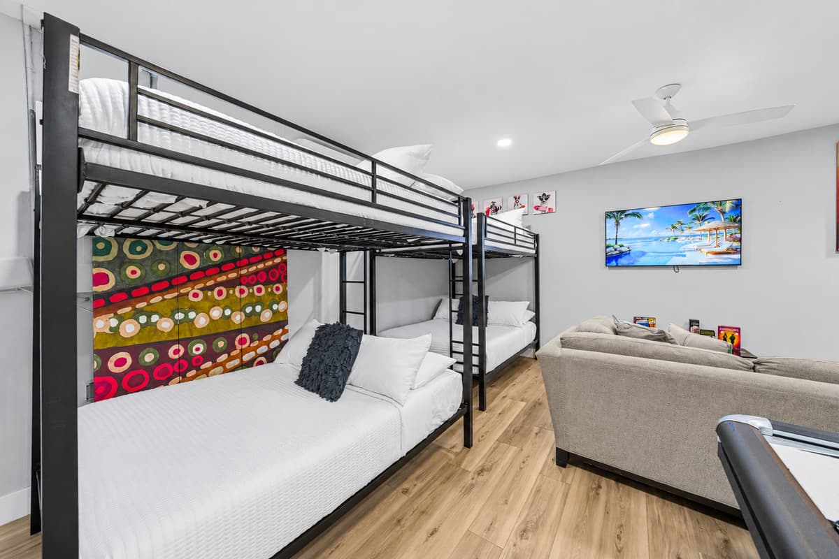 Bunk beds offer comfortable sleeping accommodations right next to the entertainment area.
