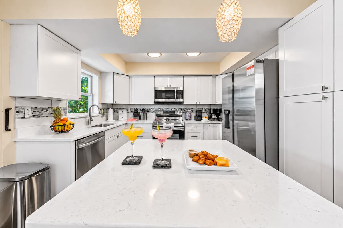 Large kitchen island provides the perfect gathering spot for meals, drinks, and conversation.