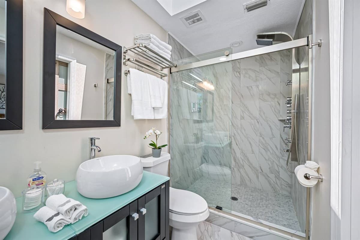 Stunning bathroom with sink, toilet, and walk-in shower.  Enjoy a relaxing bath after a long day of travel from your home to your home away from home. If you like this property, send us a message now!