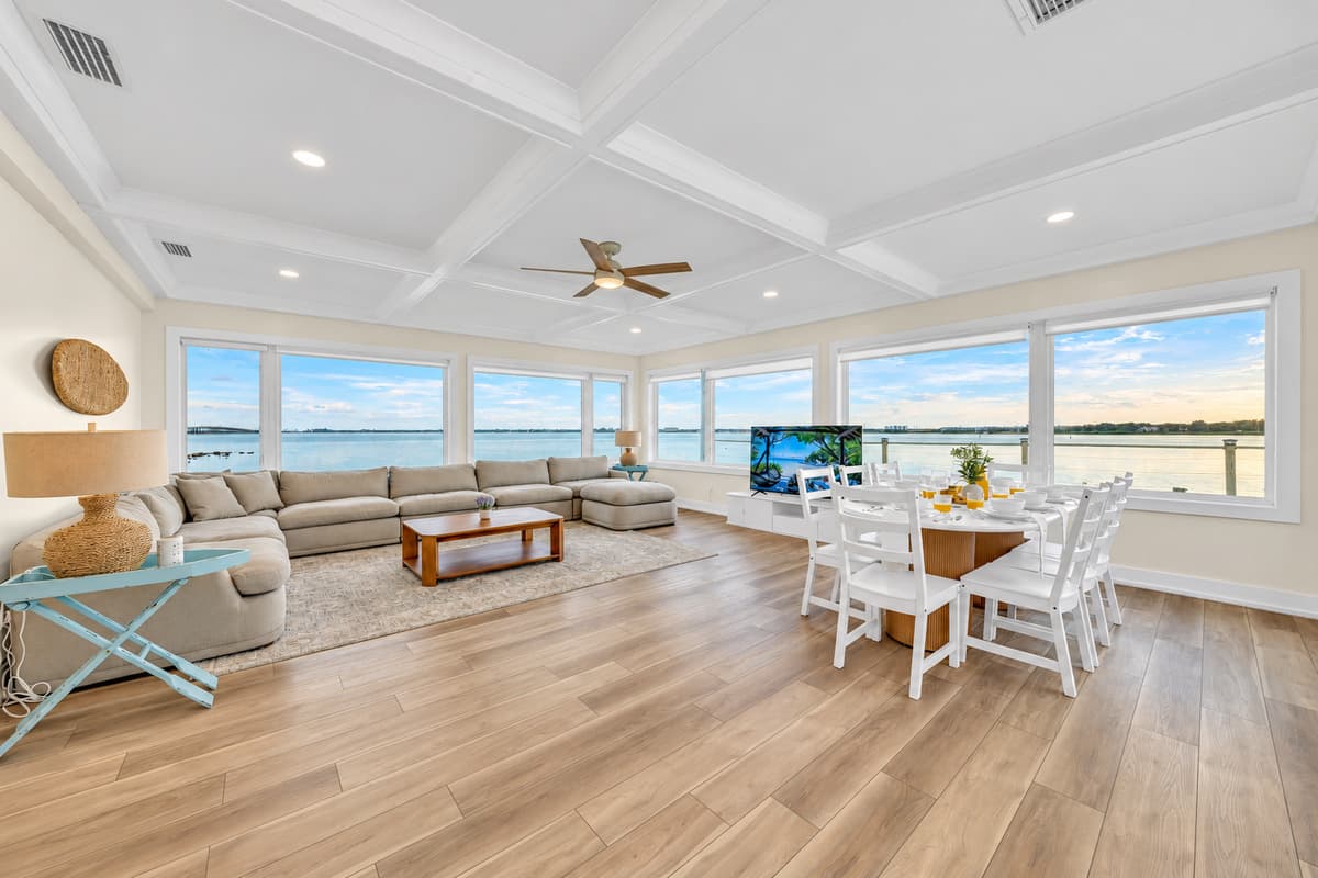 Wake up to water views from every seat. Wall-to-wall windows wrap the living and dining area with bay views. A huge sectional, a table for the whole group and light pouring in all day long.
