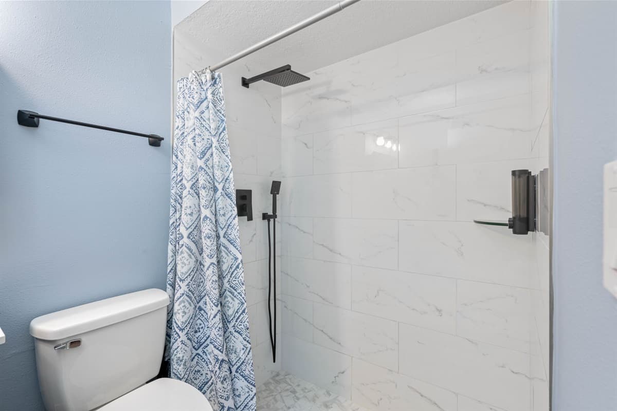The pristine toilet, complemented by contemporary design elements, ensures utmost comfort and hygiene.