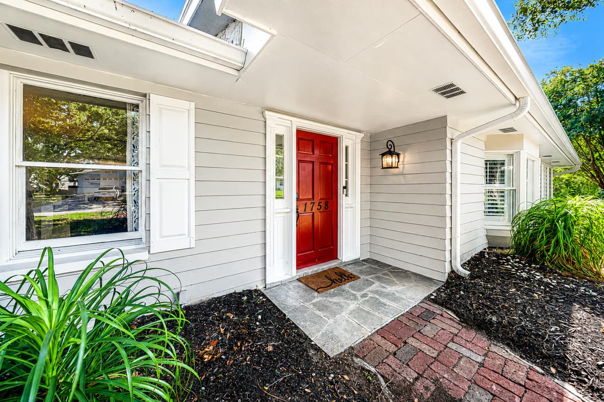 Red door, covered entry, walkway lit from the side. Easy to find at night with the bags in your hands.