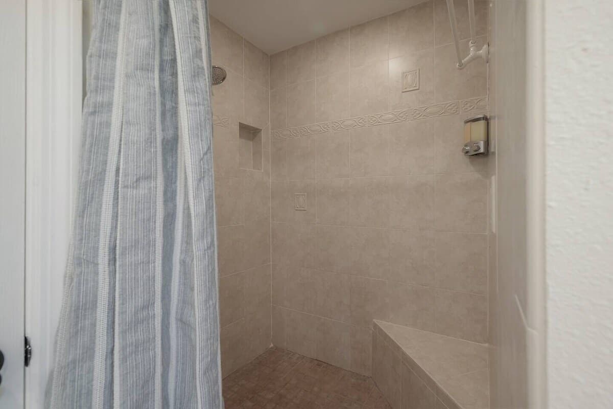 A practical shower design with a built-in niche and seating area.