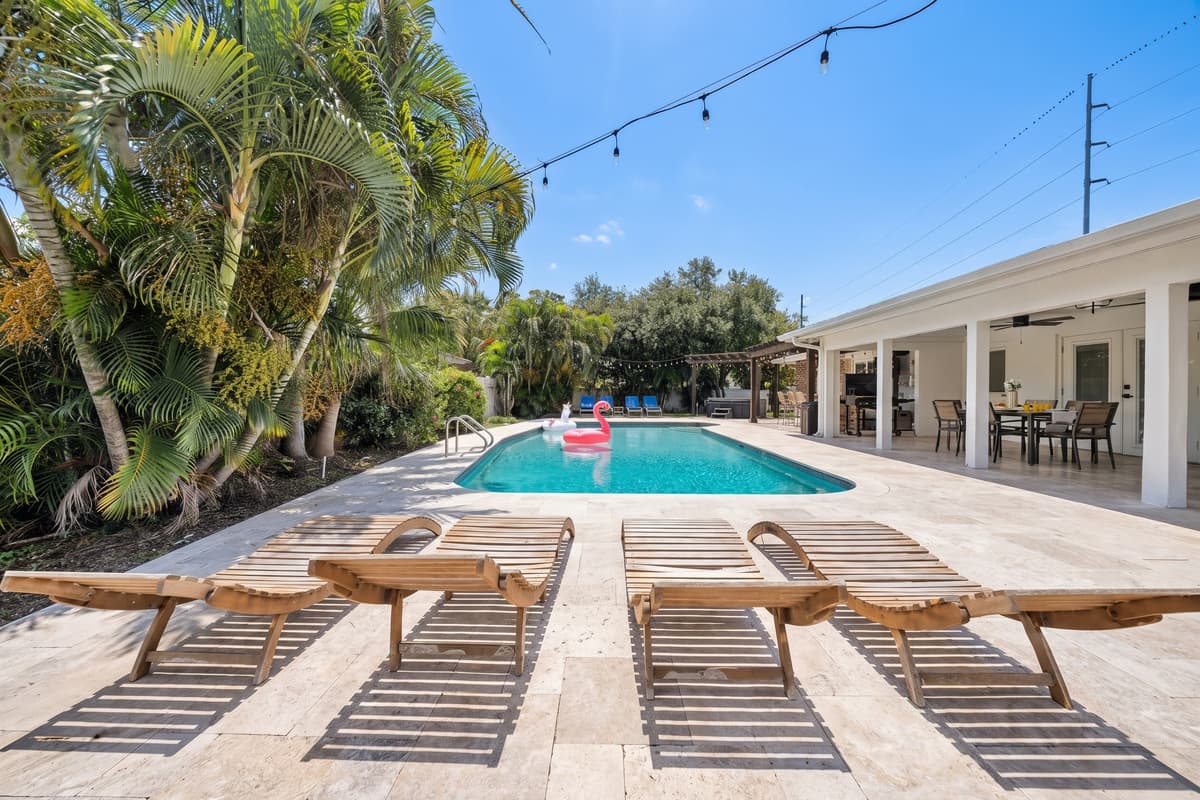 Wood-slat loungers line the pool deck, an open invitation to stretch out and soak up the Florida sunshine