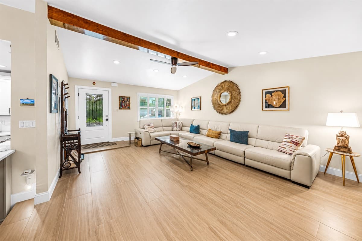 Bright open-concept living area with plenty of seating space, warm finishes, and an inviting atmosphere perfect for gatherings.