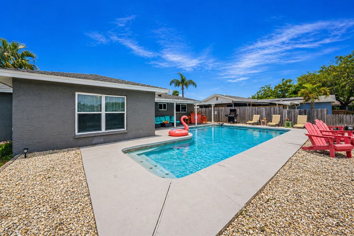 Wide view of the backyard pool area with ample space for lounging and outdoor enjoyment.