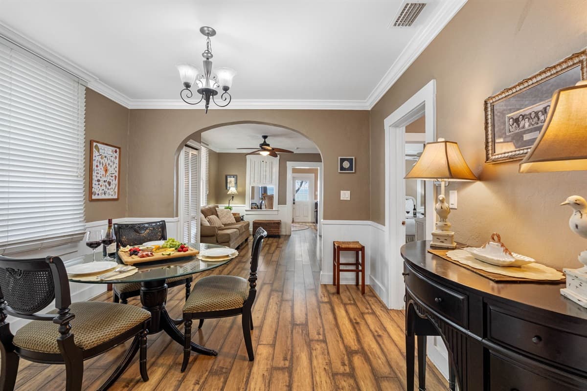 The dining area is adorned with elegant lighting that casts a warm, welcoming glow, creating an intimate atmosphere for conversations and celebrations.