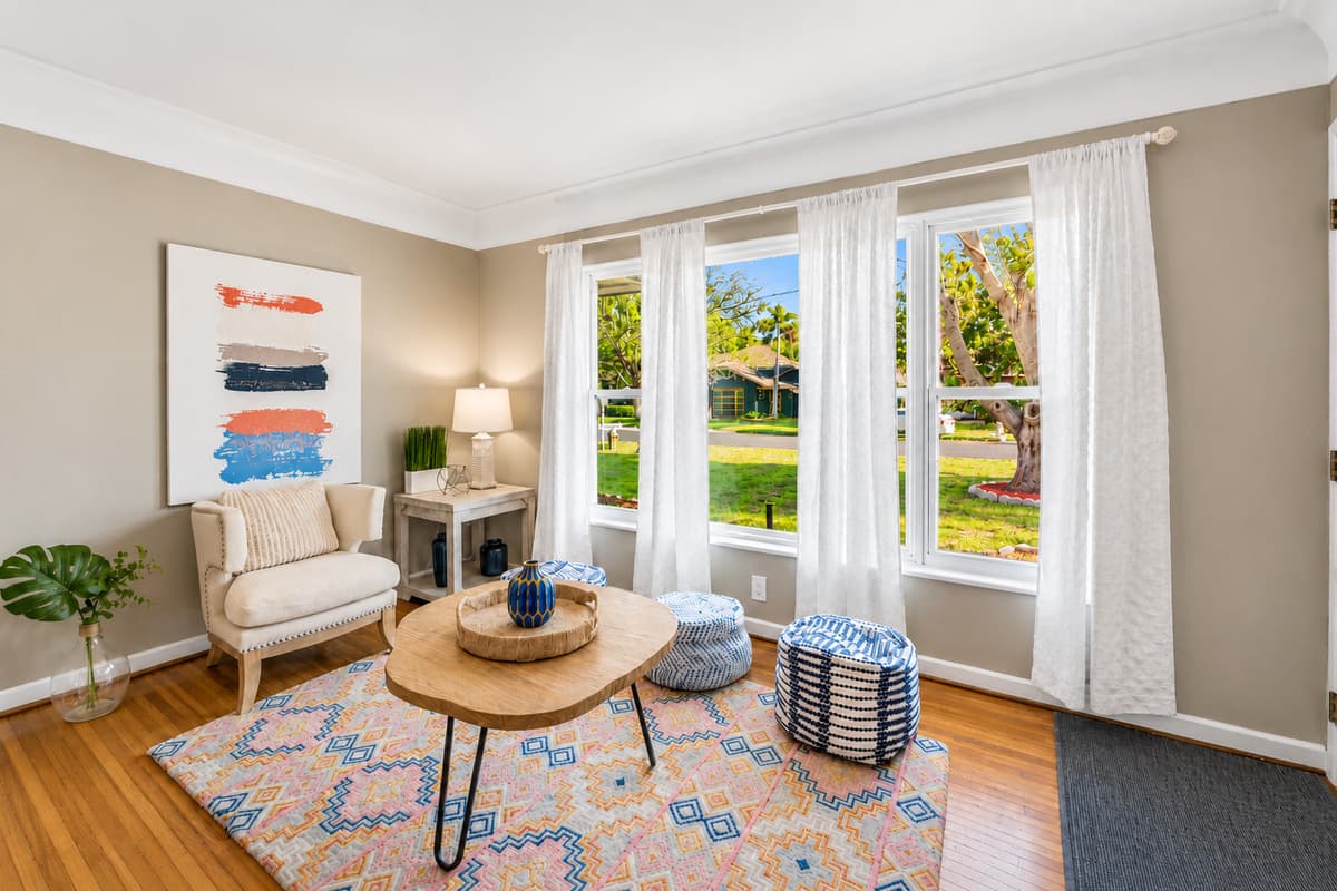 Relaxing conversation area near the entryway with chic décor and peaceful outdoor views.